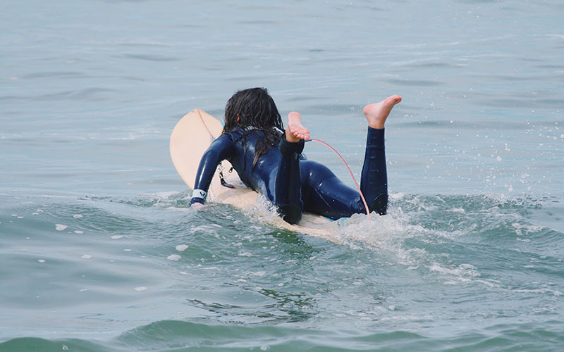 Little girl surfing in Lacanau
